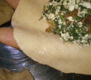 Filling the rolled out dough / puff pastry with the spinach mixture.